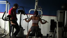 Trainer helps a hottie work out on the equipment before he nails her